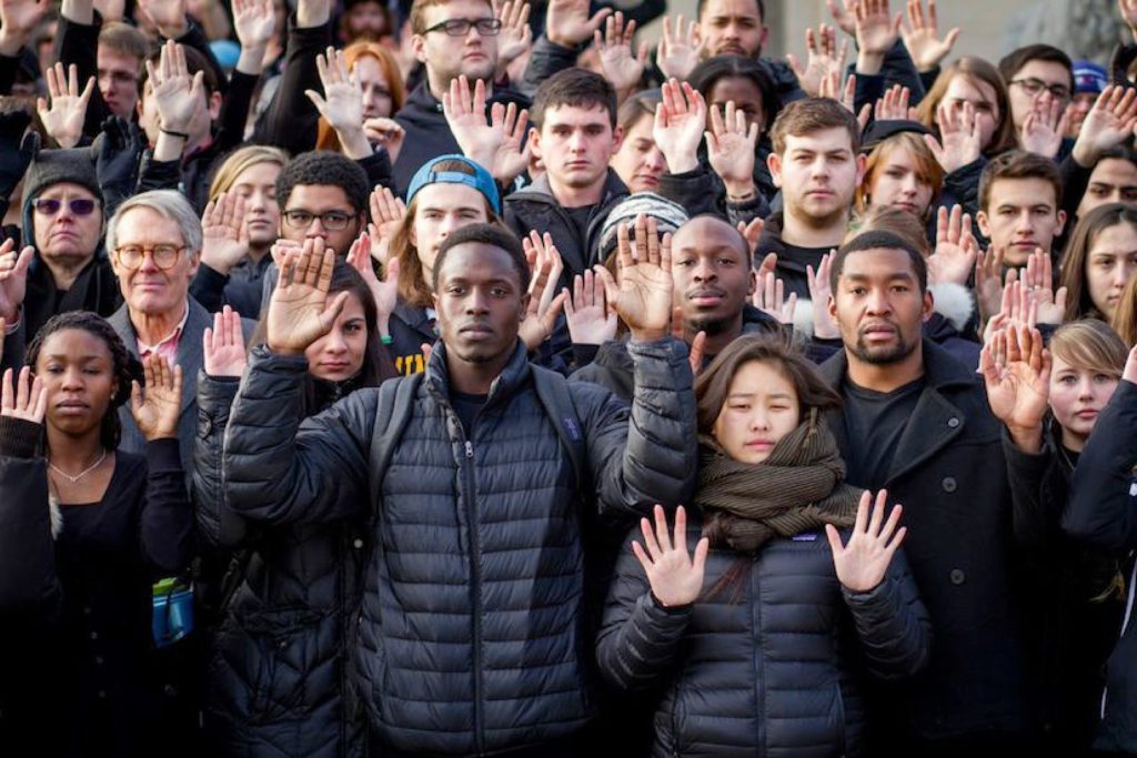 People with hands raised in protest