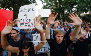Group of protesters with hands raised
